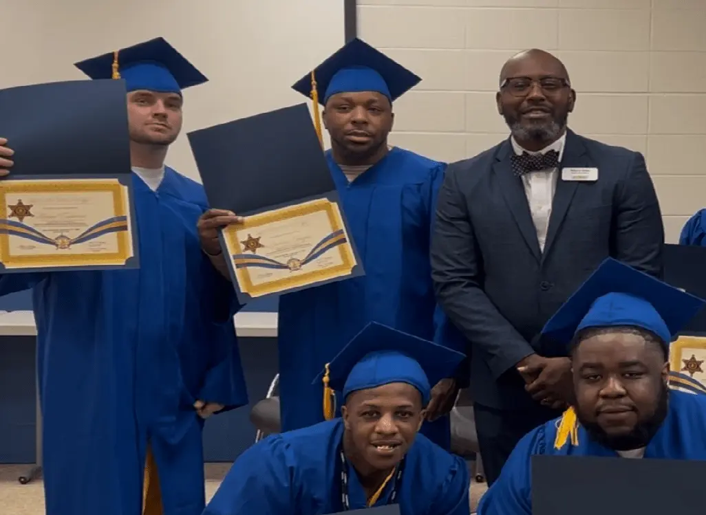 mr. stubbs holding a certificate in hand