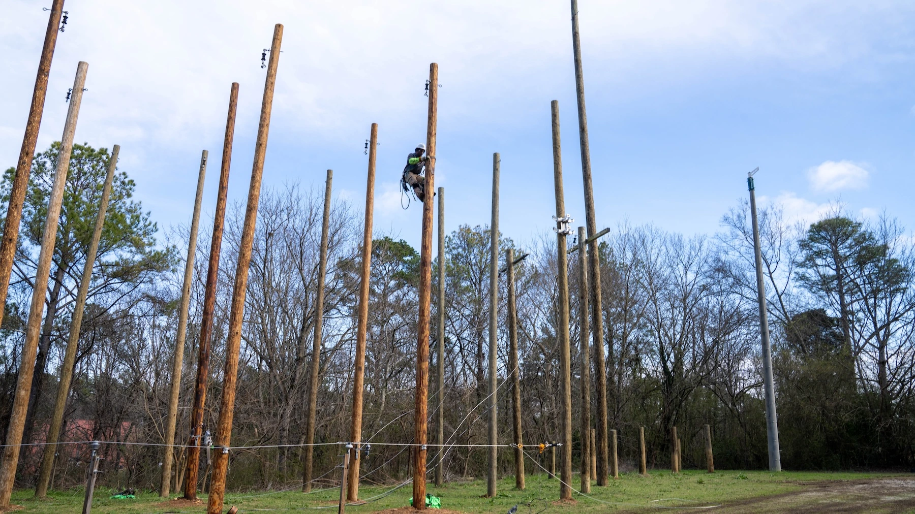 A lineman worker is working on pole
