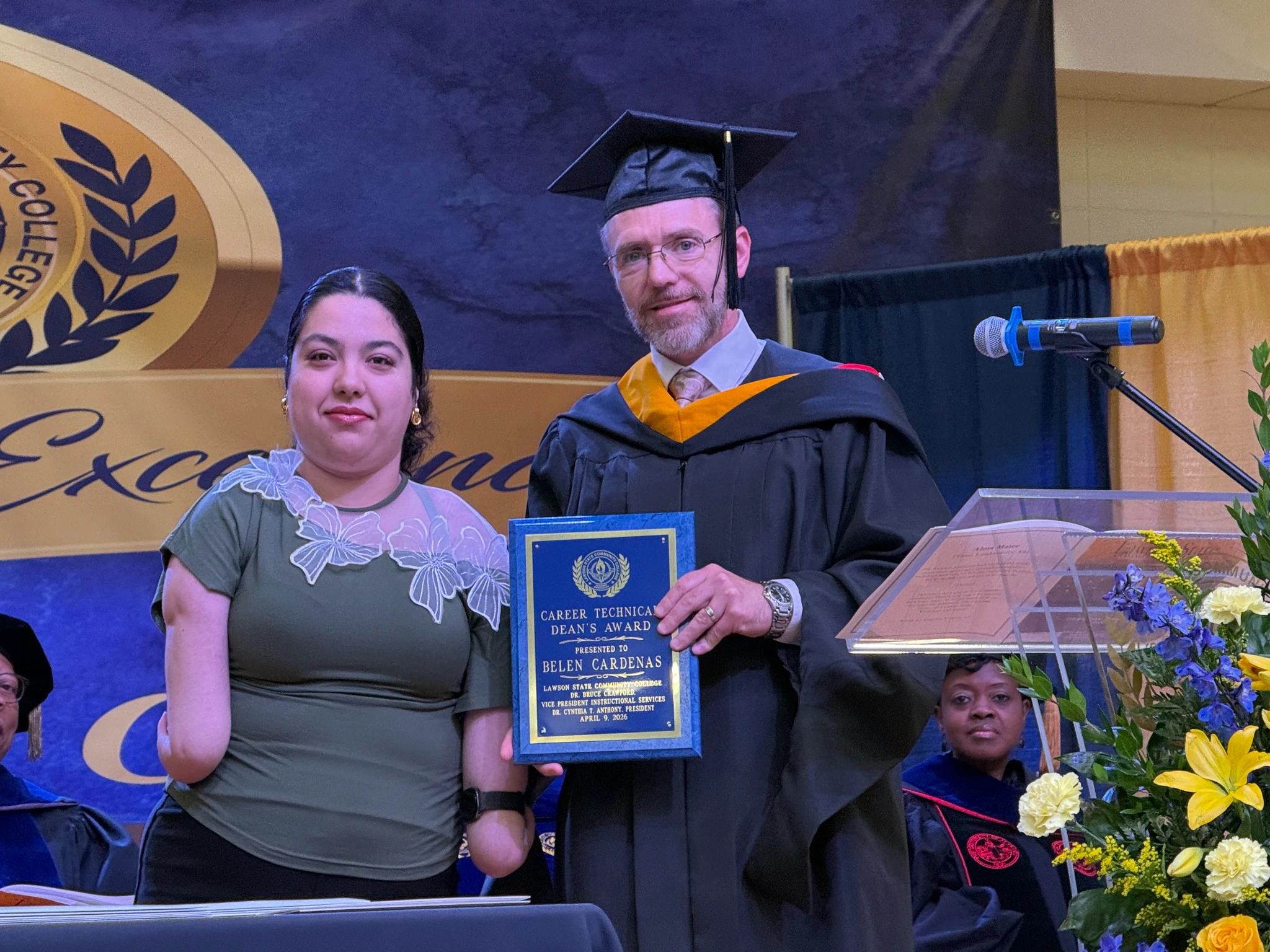 a girl is honored with certificate from faculty