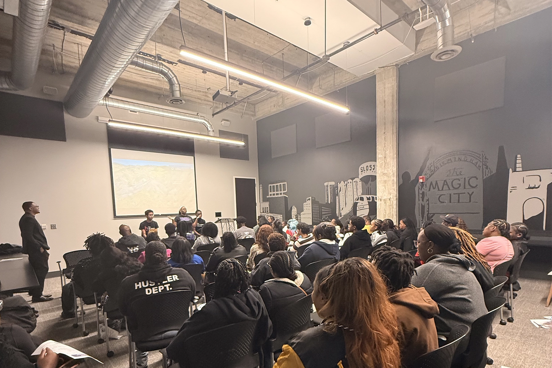 a group of student sitting on the chair in a conference room 