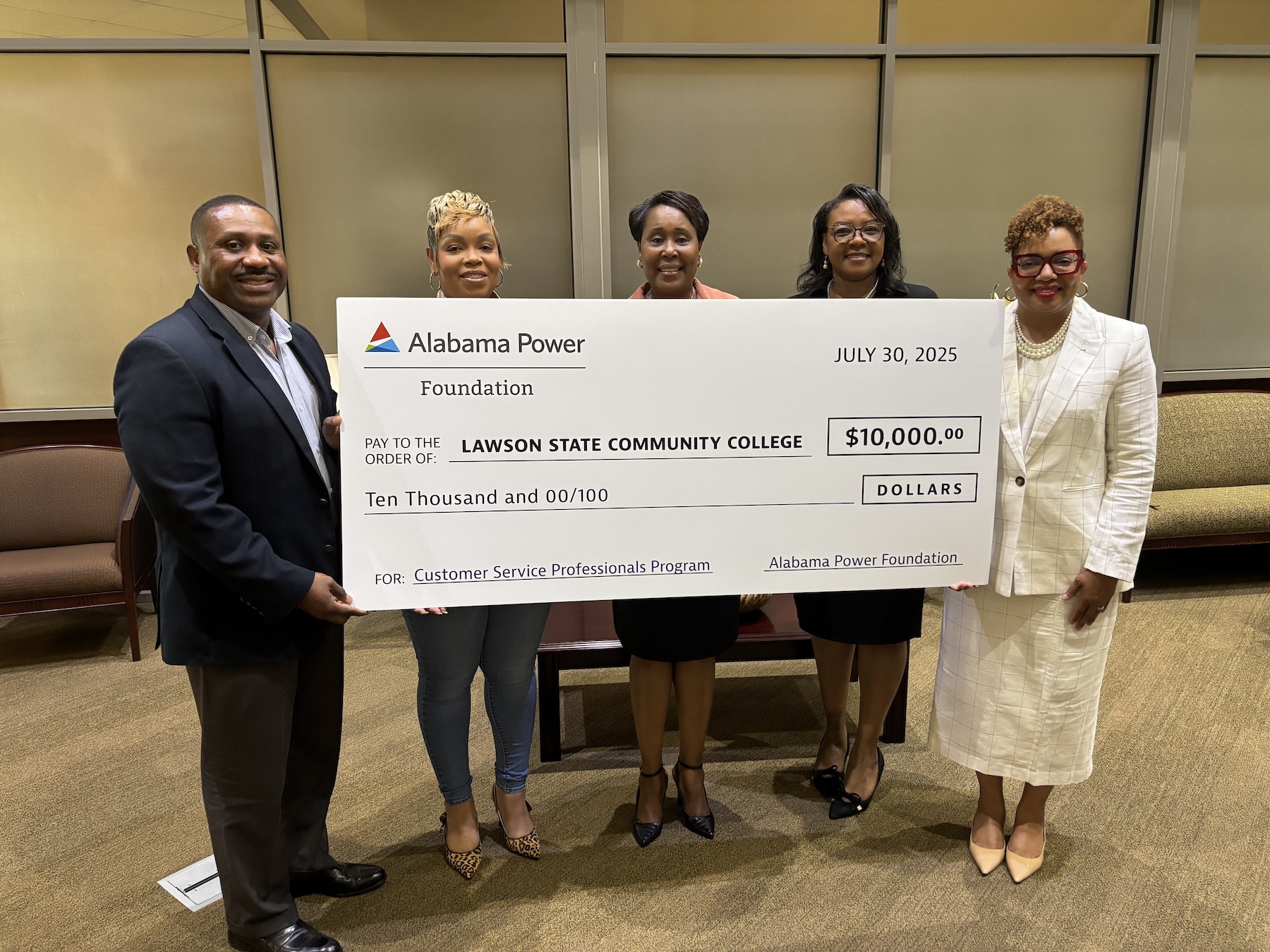 Alabama power representative holding a check worth of 10,000 and giving to Lawson State Community College's president
