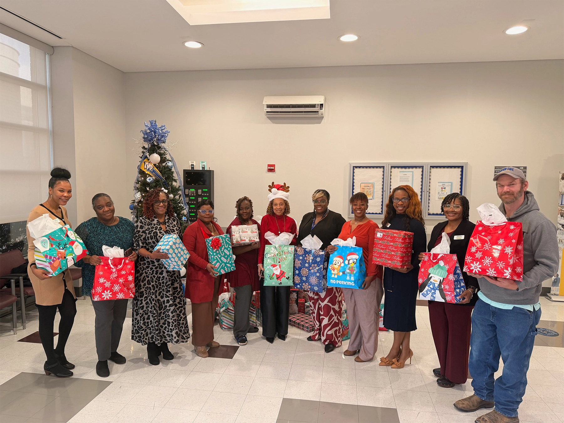 lawson faculty and staff holding christmas gifts in hand