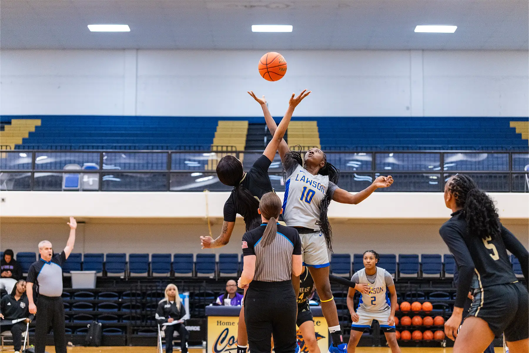 Women grabbing basketball 