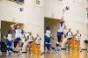 Lawson State volleyball player wearing number 10 serves the ball as teammates stand ready behind her.