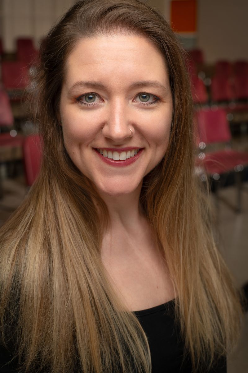 woman looks into camera with a smile