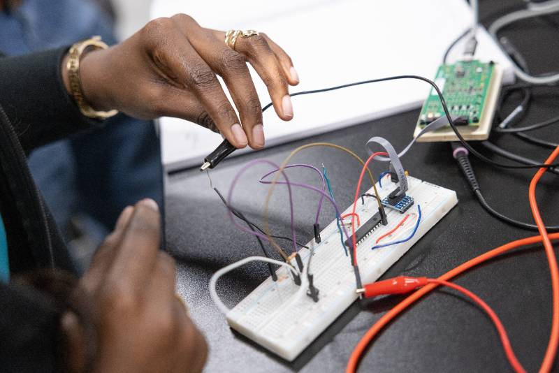 woman working on electronics board